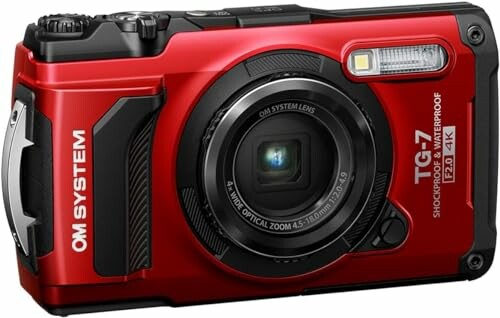 Red rugged digital camera with lens and flash